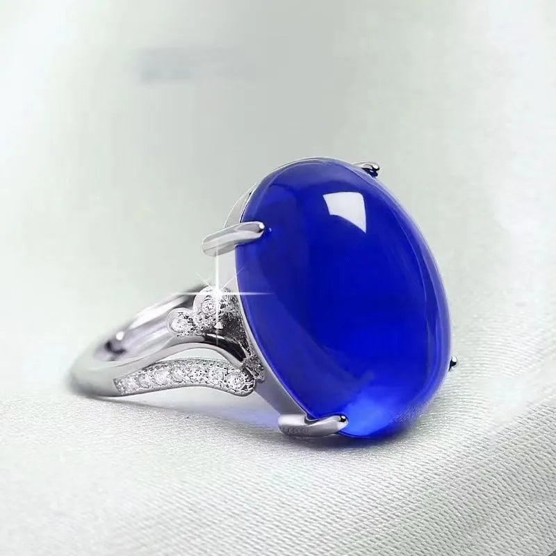Adjustable alloy ring with geometric ethnic pattern in multiple colour options on a finger.