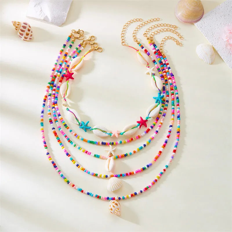 Women's starfish shell bead necklace five-piece set showing blue and multicolour designs with adjustable chains