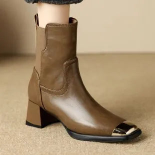 Brown cowhide leather women's ankle boots with a high heel and side zipper closure on a white background.