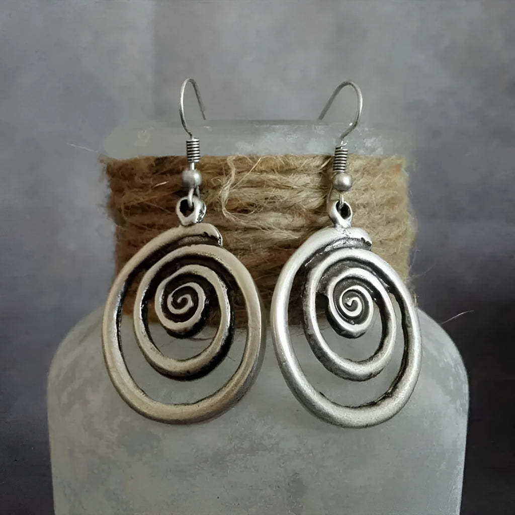 Silver geometric spiral earrings with distressed finish, measuring 2.6 by 5 centimetres