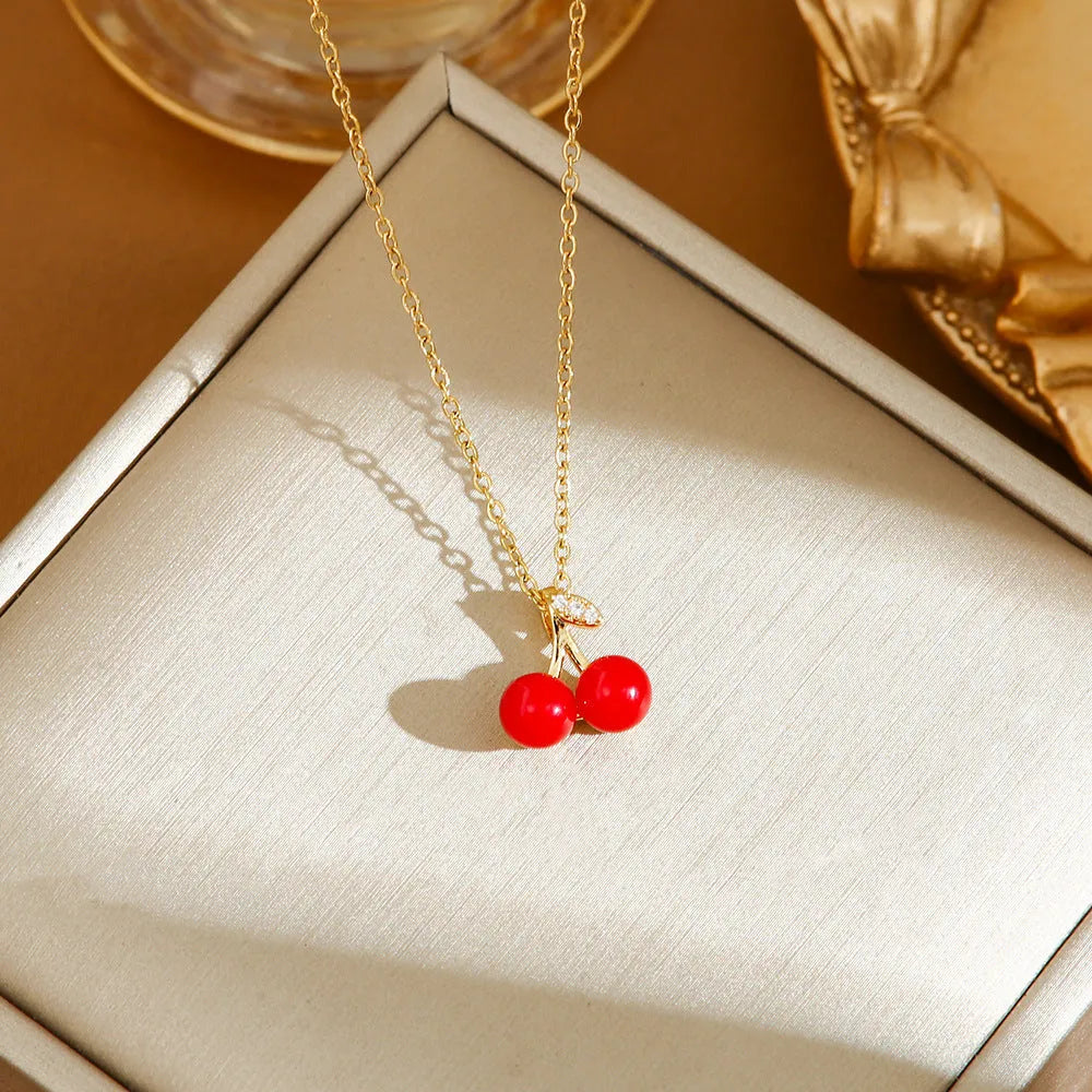 Delicate titanium steel necklace with strawberry, cherry, or pepper charm on an O-ring chain in golden or zircon finishes.