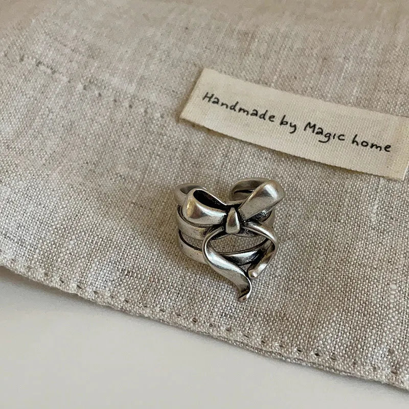 Gold plated wide open ring with retro distressed bow front and geometric metal shape for women