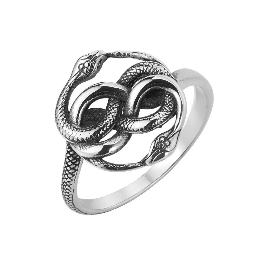 Close-up of a titanium steel double snake ring in retro style on a grey background