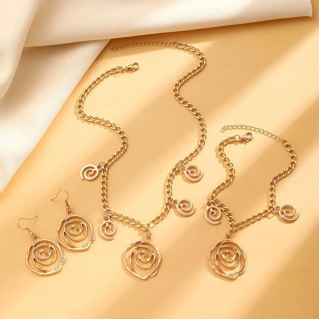 Spiral donut jewellery set showing necklace, bracelet, and earrings in geometric circle design with gold electroplated finish
