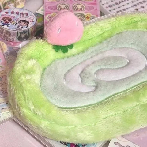 Swiss roll cake design pencil case in plush velvet with a zip closure.