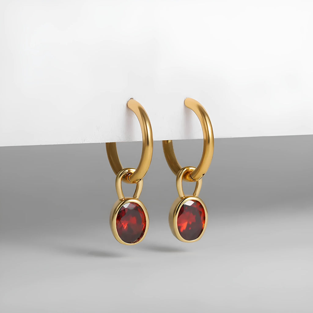 Close-up of a women's retro-style oval zircon drop earring in copper setting.