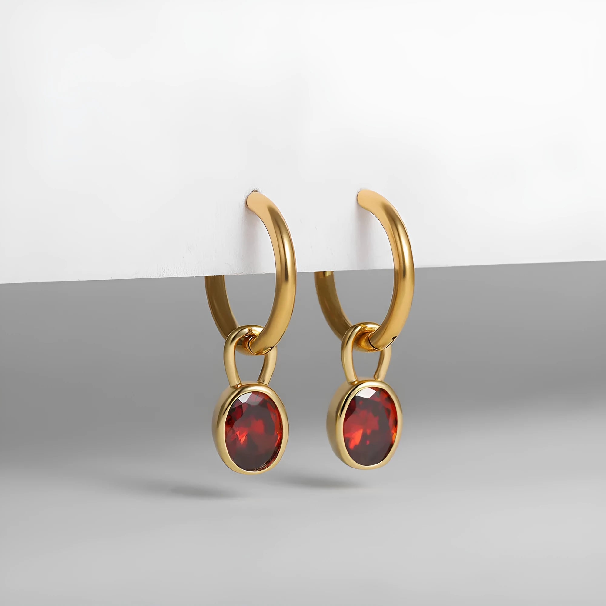 Close-up of a women's retro-style oval zircon drop earring in copper setting.