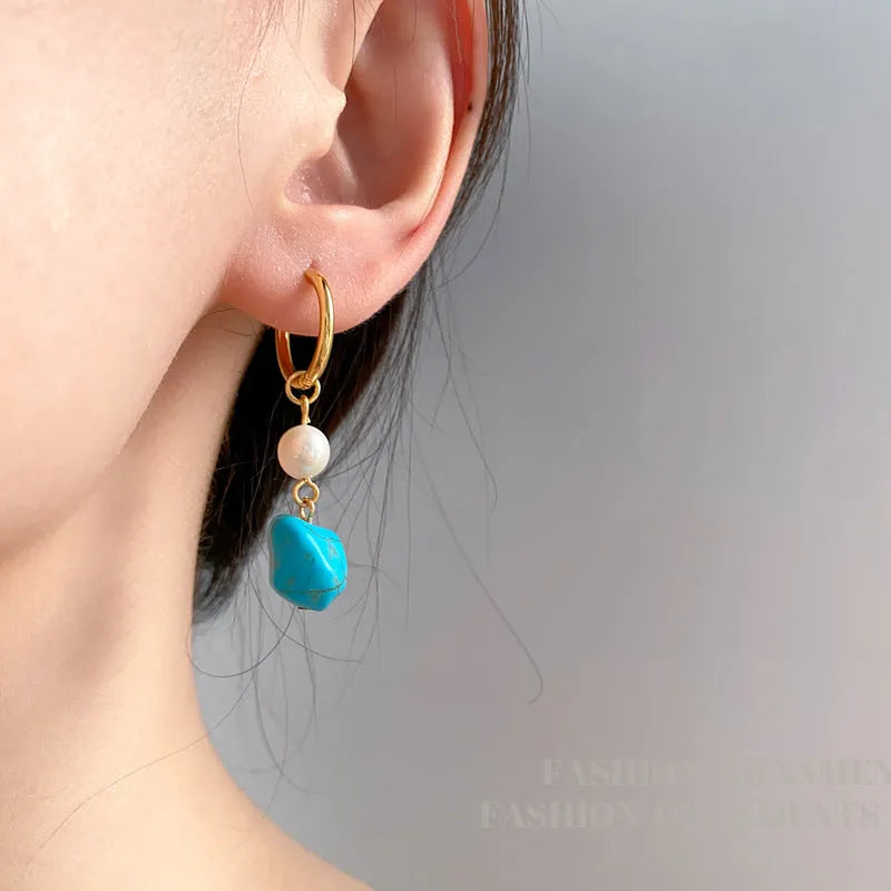 A pair of geometric copper ear clips with irregular turquoise cultured pearls, shown in short and long style options.