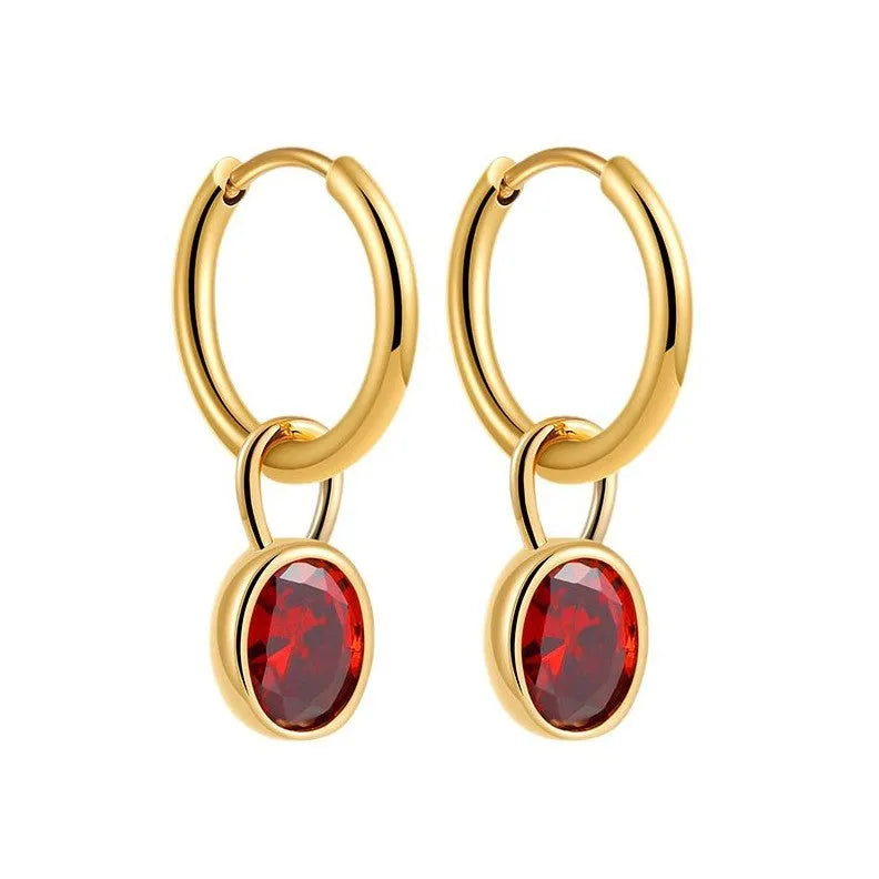 Close-up of a women's retro-style oval zircon drop earring in copper setting.