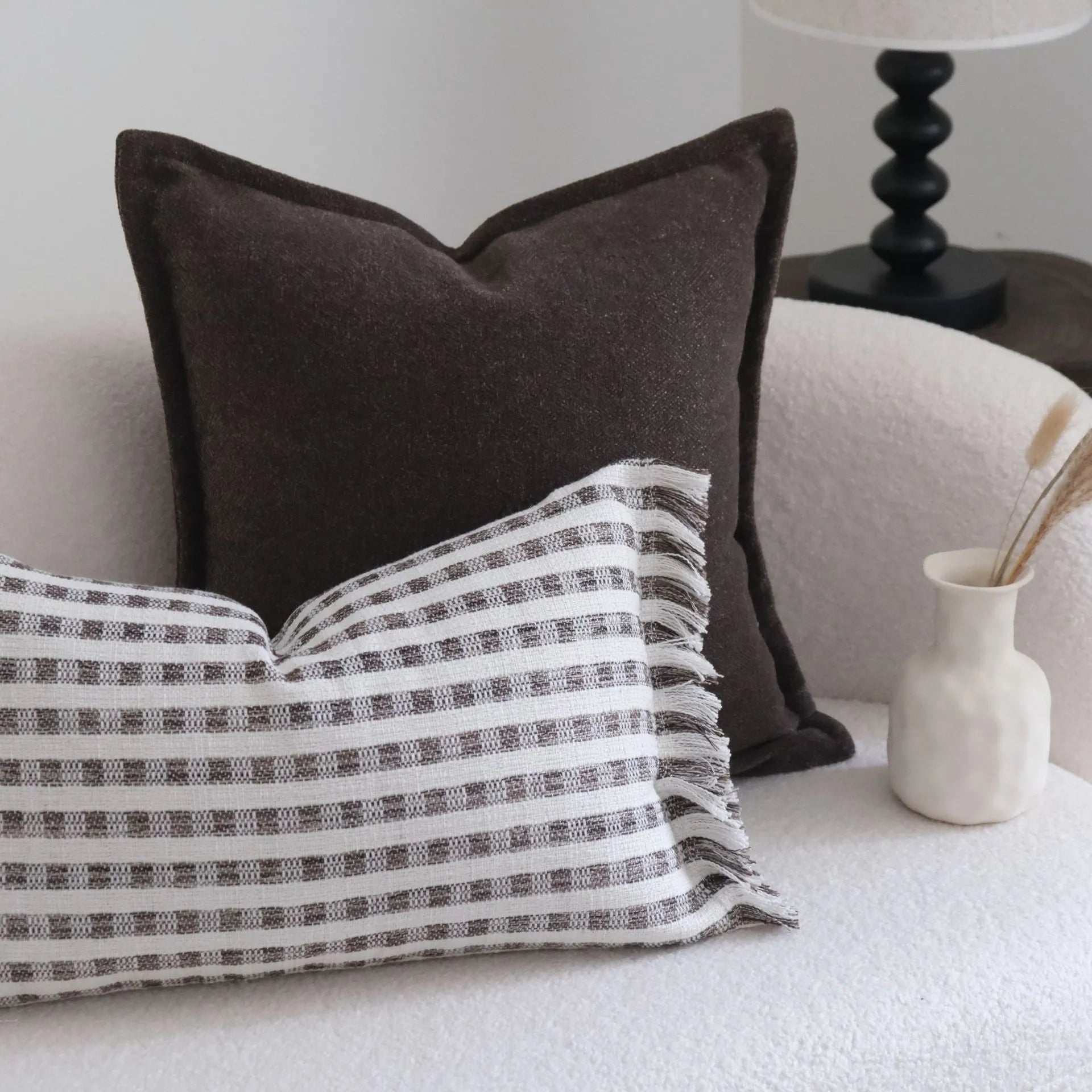 Coffee brown striped mid-century modern cushion with Chinese classical design on sofa