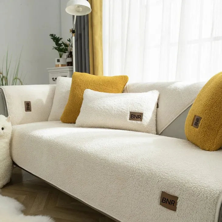 Lambswool sofa slipcover in a solid colour draped over a sofa, showing its simple cloth liner style.