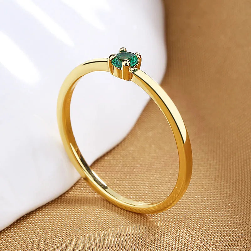 Copper geometric circle women's ring with a single diamond, shown in blue, green, red, and white colour options.