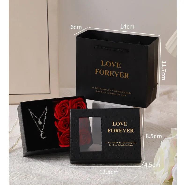 Red Korean style gift box open to show six pink soap flowers, with a matching handbag, for Valentine's Day.