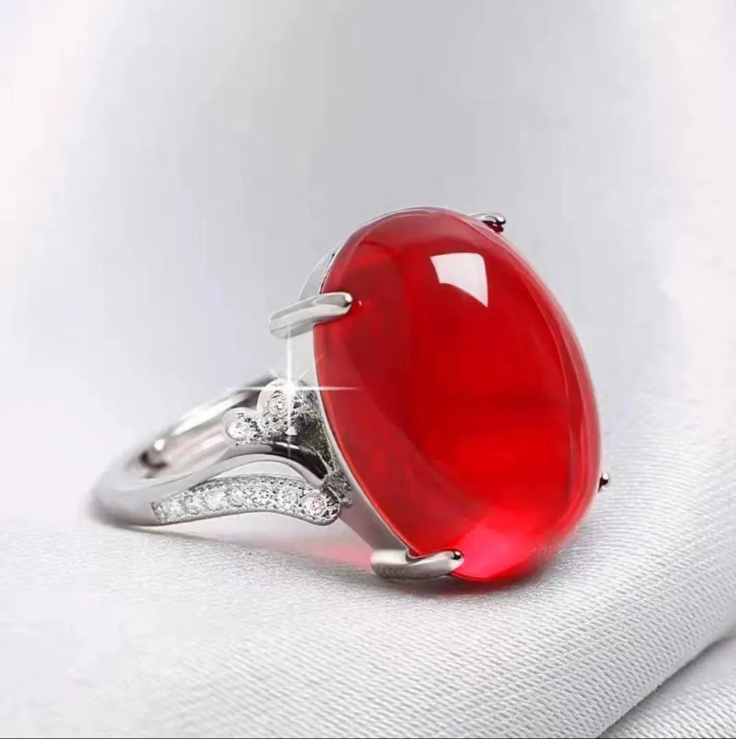 Adjustable alloy ring with geometric ethnic pattern in multiple colour options on a finger.