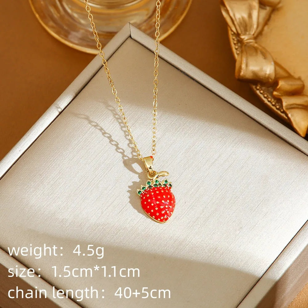 Delicate titanium steel necklace with strawberry, cherry, or pepper charm on an O-ring chain in golden or zircon finishes.