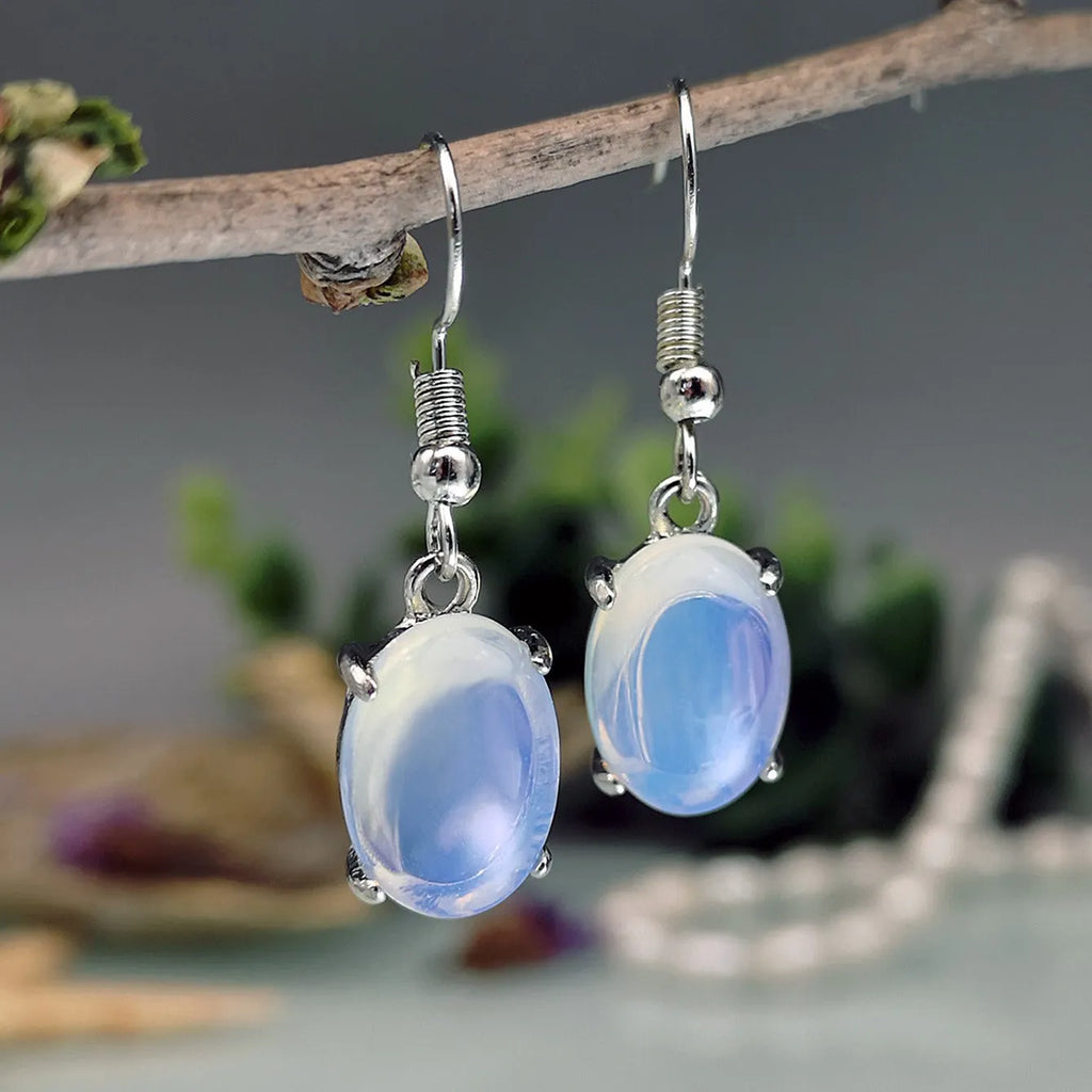Moonlight white opal drop earrings with retro cross and ellipse design on alloy.