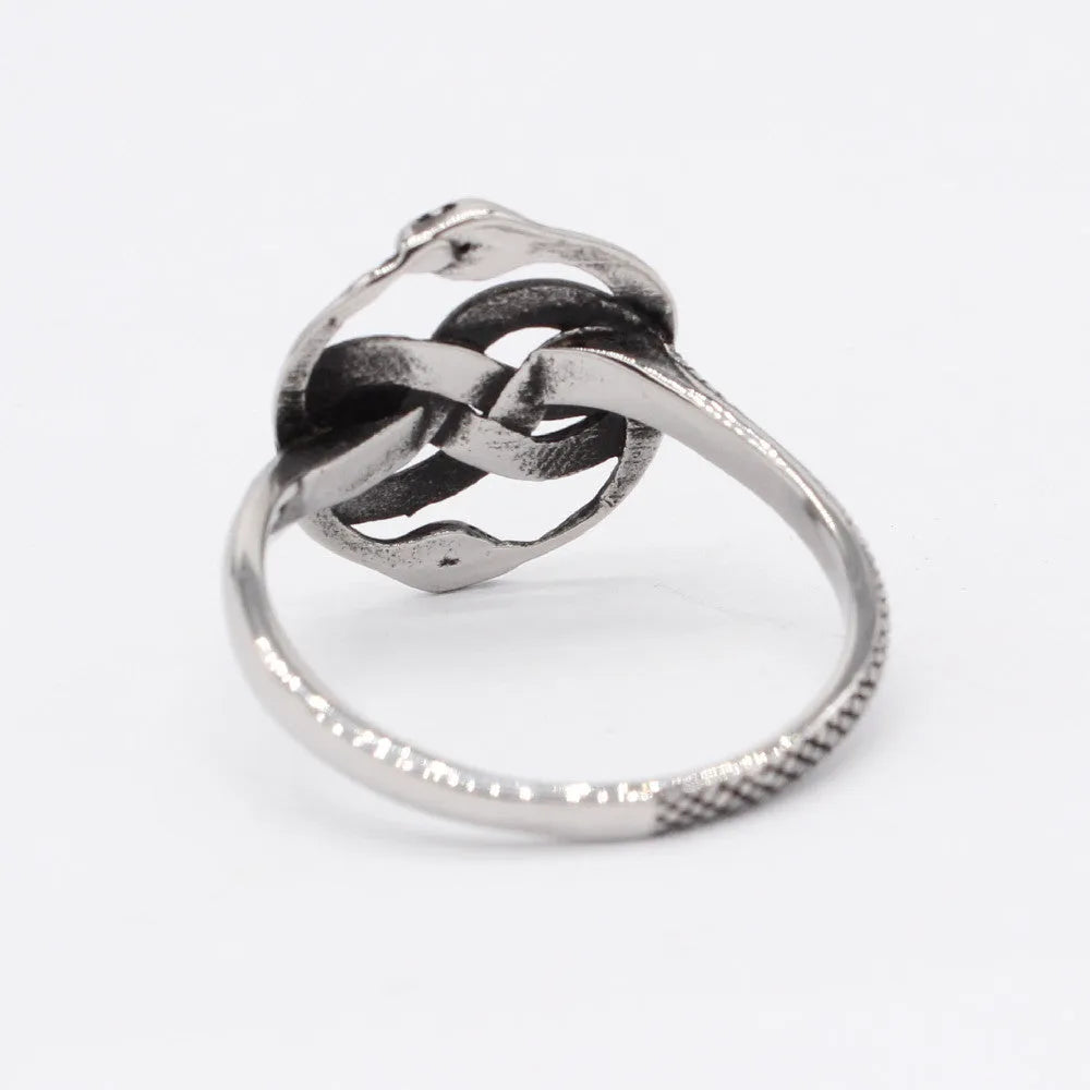 Close-up of a titanium steel double snake ring in retro style on a grey background