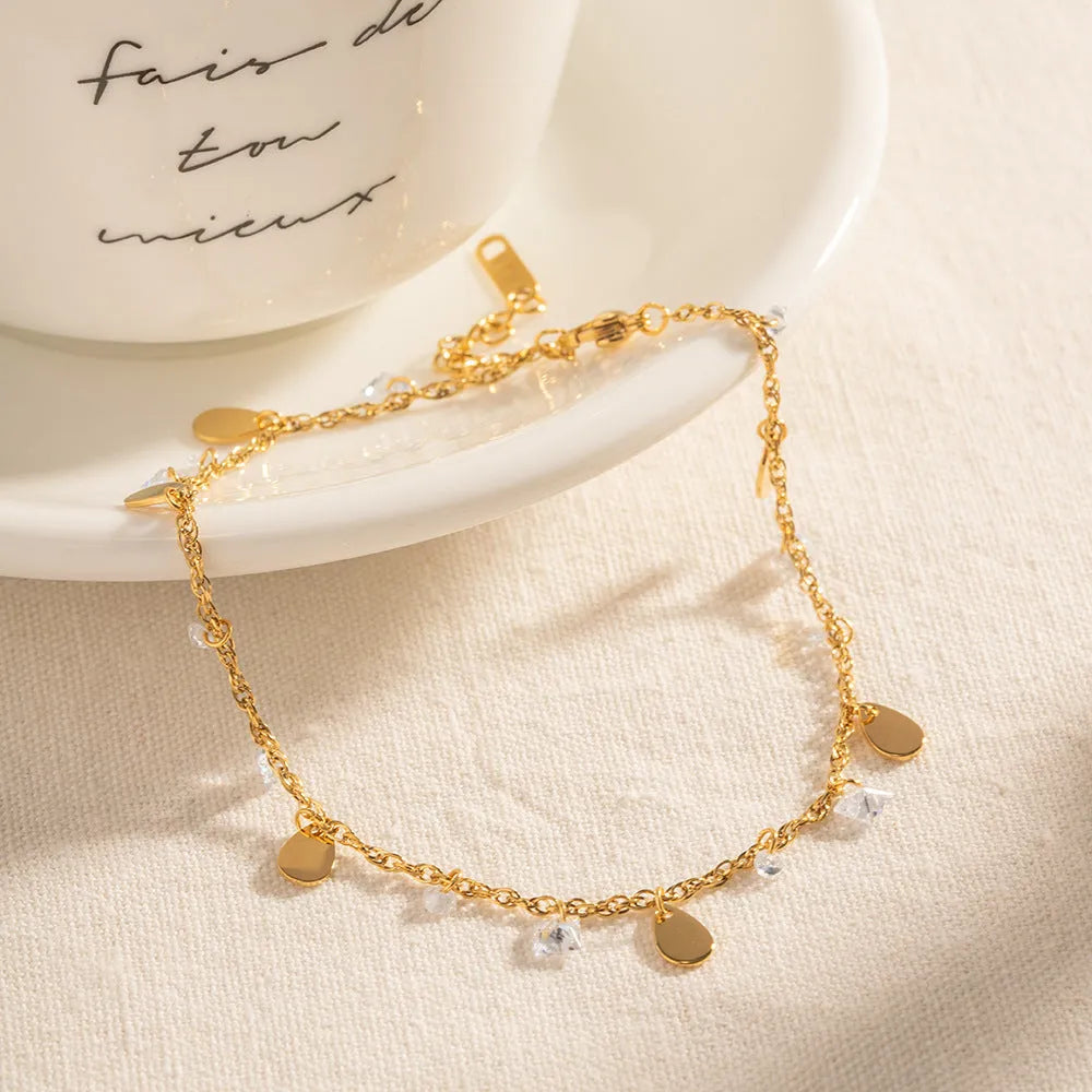 Women's stainless steel anklet with water drop charm and geometric tassel design