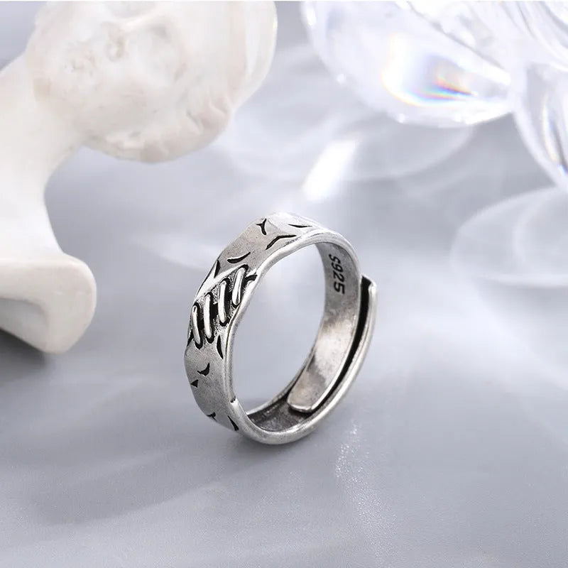 Black geometric copper ring with adjustable opening and round oval design elements