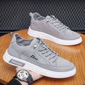Grey men's canvas lace-up sneakers with round toe and low-top design on a rubber sole.