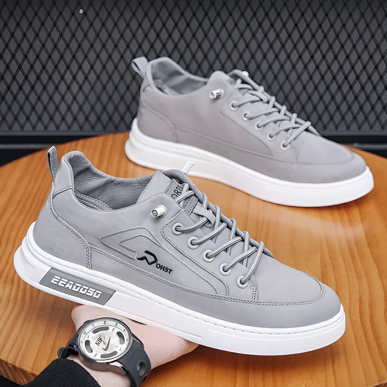 Grey men's canvas lace-up sneakers with round toe and low-top design on a rubber sole.