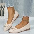 Women's beige casual flat slip-on shoe with a bowknot and round toe on a rubber sole.