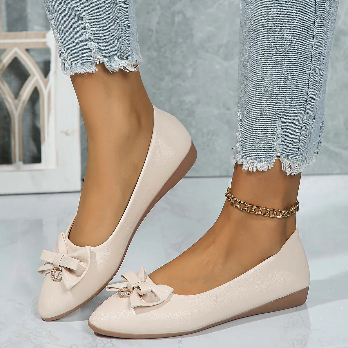 Women's beige casual flat slip-on shoe with a bowknot and round toe on a rubber sole.