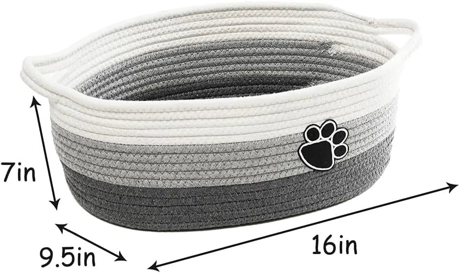Light beige handmade cotton rope storage basket with wooden base and handle on a wooden floor