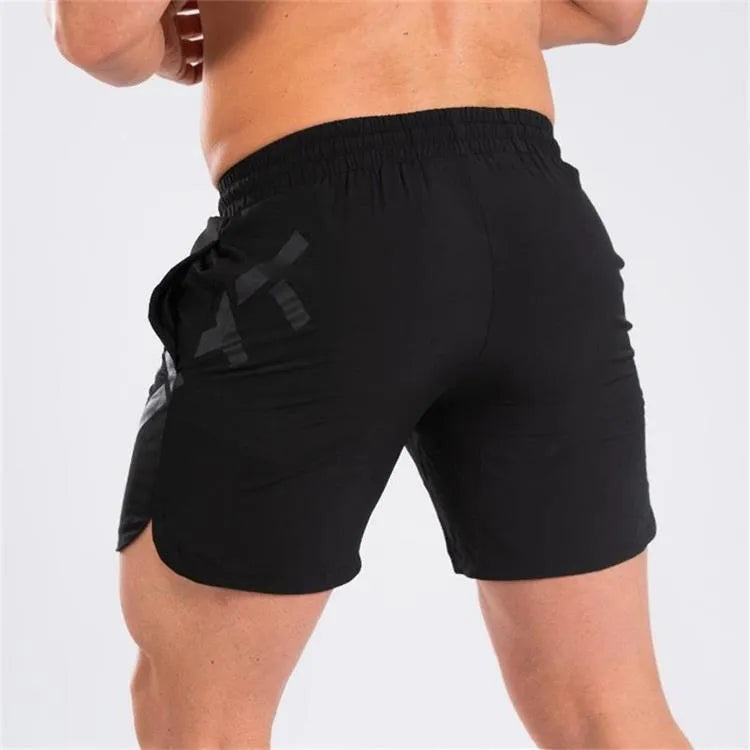 Men's black elastic quick-dry running shorts with mid waist and knee-length leg.