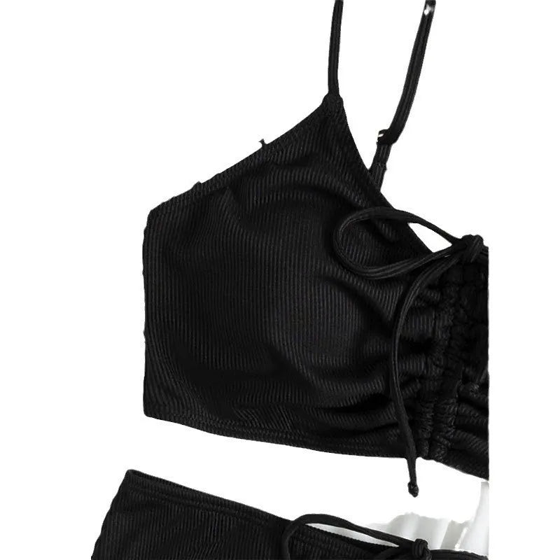 Black women's bikini swimsuit with sling split style and high waist shorts.