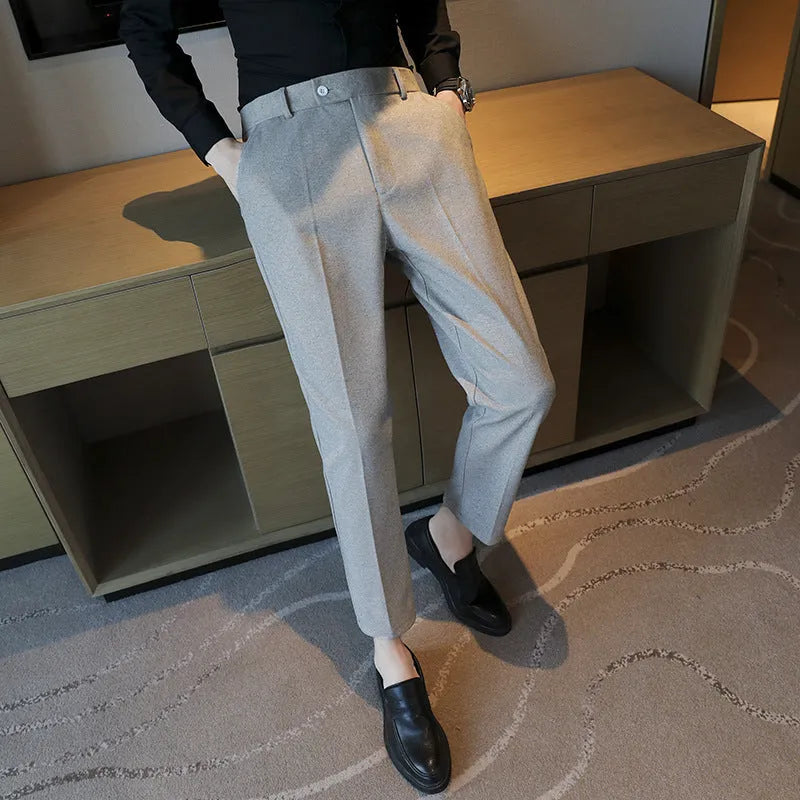 Brown straight leg corduroy trousers for men laid flat, showing slim fit and elastic waistband detail.