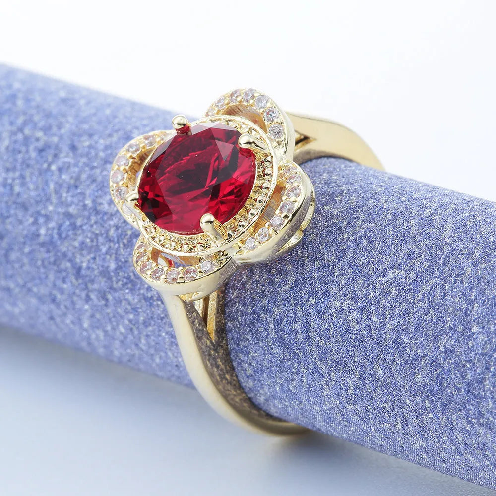 Copper fruit-shaped ring with inlaid zircon gemstones on a model's finger.