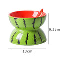 Ceramic tilted and elevated cat food bowl in orange pattern with non-slip base.