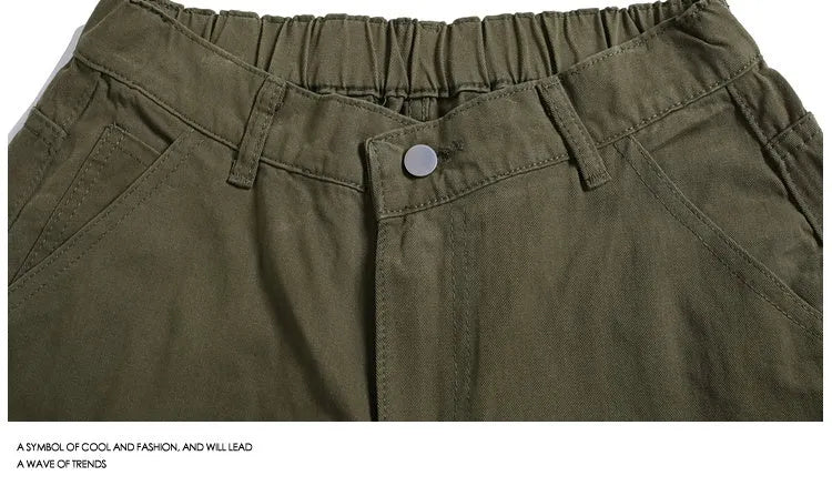 Workwear-style cropped pants with wide-leg design in apricot colour showing mid waist and loose fit