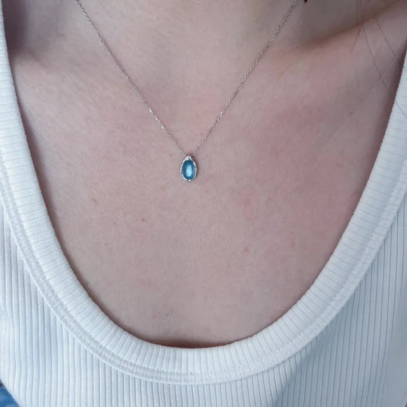 Navy blue water drop pendant necklace with cross chain in electroplated platinum colour finish
