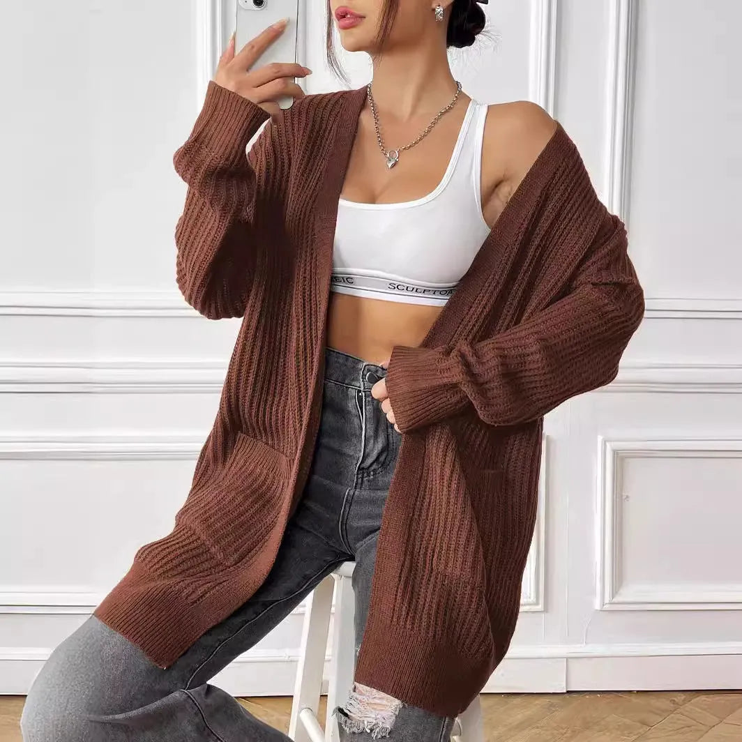 Women's dark green acrylic cardigan sweater with two pockets and long sleeves.