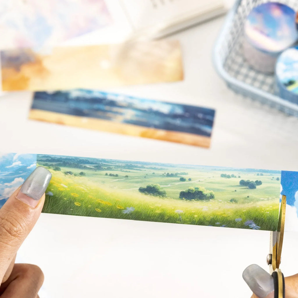 Roll of Japanese washi tape with sky theme designs including clouds, sun, moon, and nebula on a 30mm wide format.