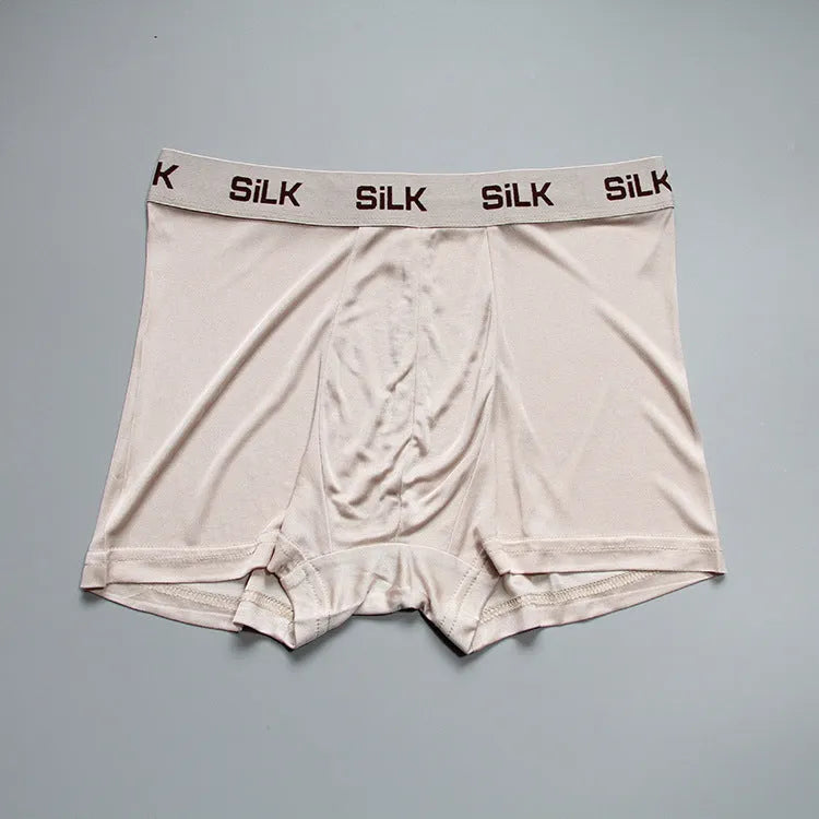 Men's loose-fitting silk shorts in navy blue, shown on a mid-waist, highlighting the breathable casual design.