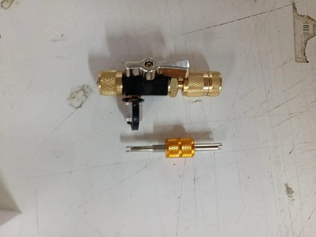 Metal valve core disassembly tool set showing black and pink valve removers with wrench attachment.