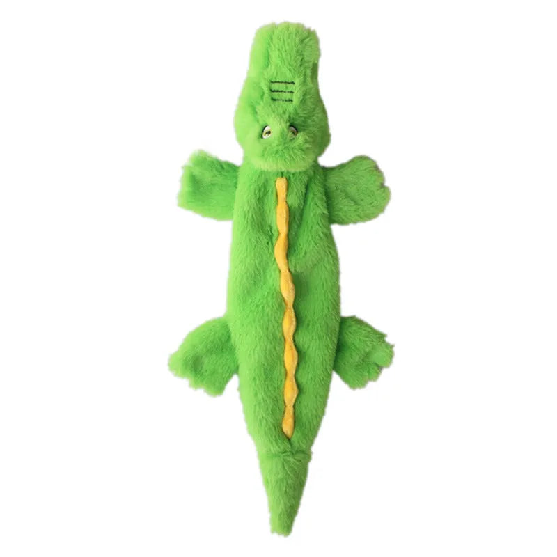 Green plush crocodile dog toy with no stuffing, featuring squeaker in head and crinkle paper in tail