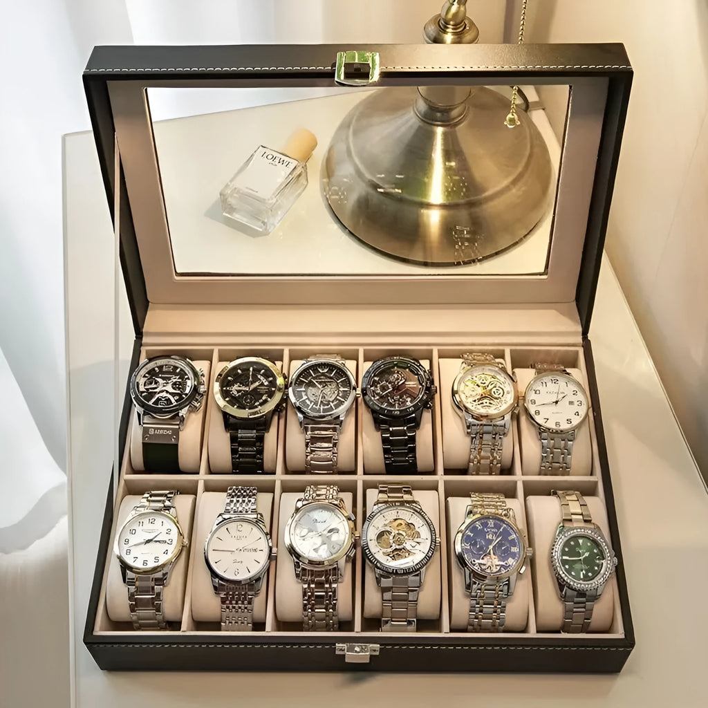 Grey leather watch storage box with transparent lid showing multiple watch slots inside.