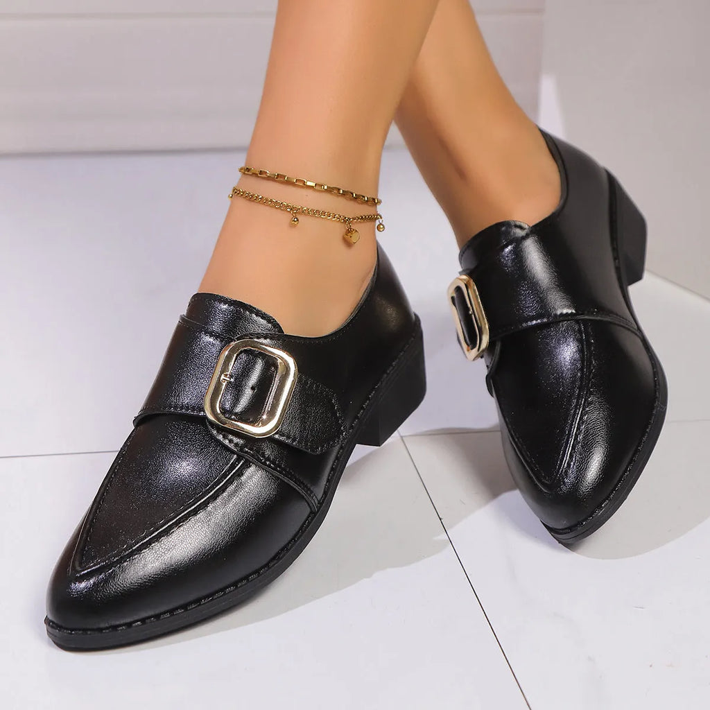 Women's brown leather-look loafers with a large bow detail on the front.