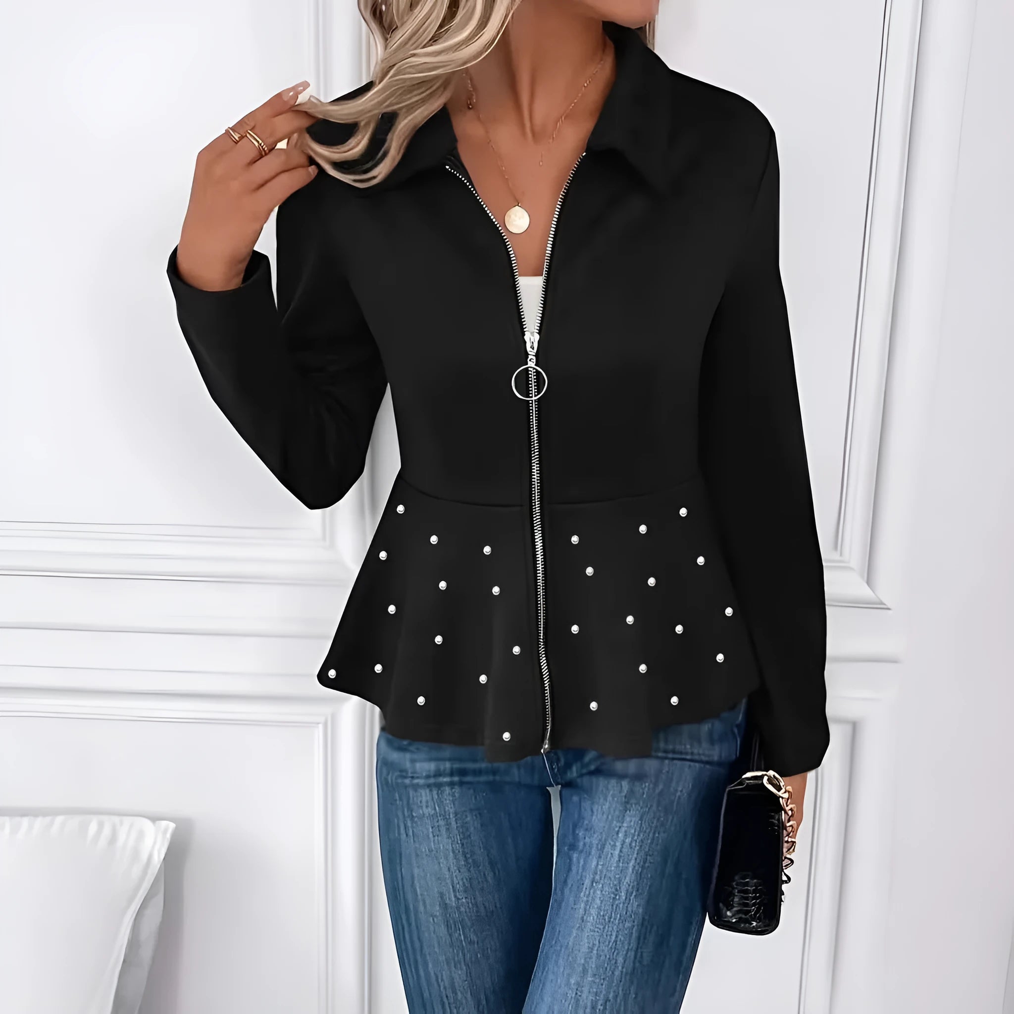 Women's loose fit black coat with beaded heavy-duty zipper and ruffled hem detail.