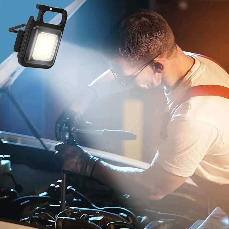 Black aluminium USB rechargeable keychain flashlight with magnetic base and foldable handle