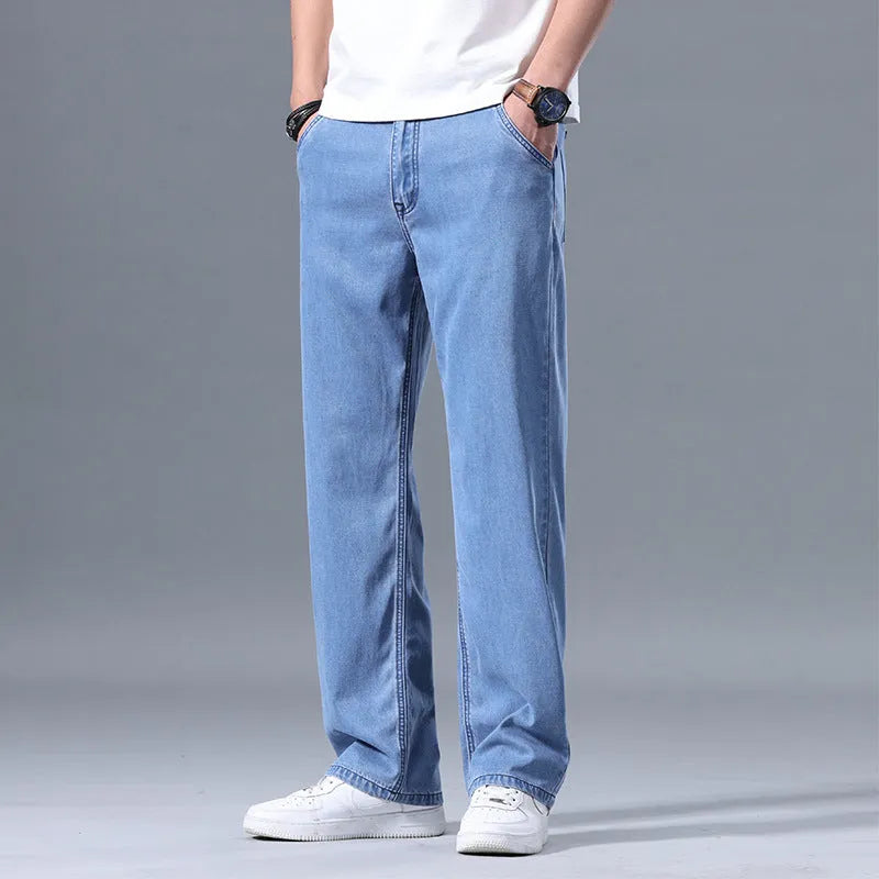 Man wearing loose-fitting straight-leg light blue lyocell jeans.