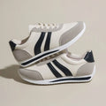 Red and blue low-top lace-up leisure sneakers with round toe and rubber sole.