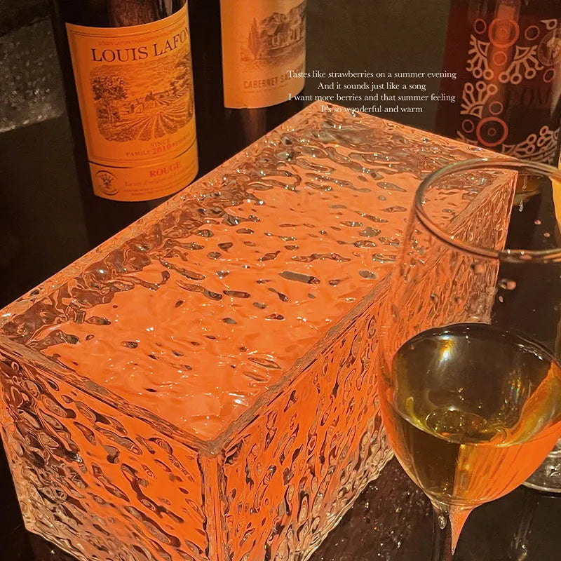 Geometric ice cube-shaped night lamp with coloured lighting on wooden surface