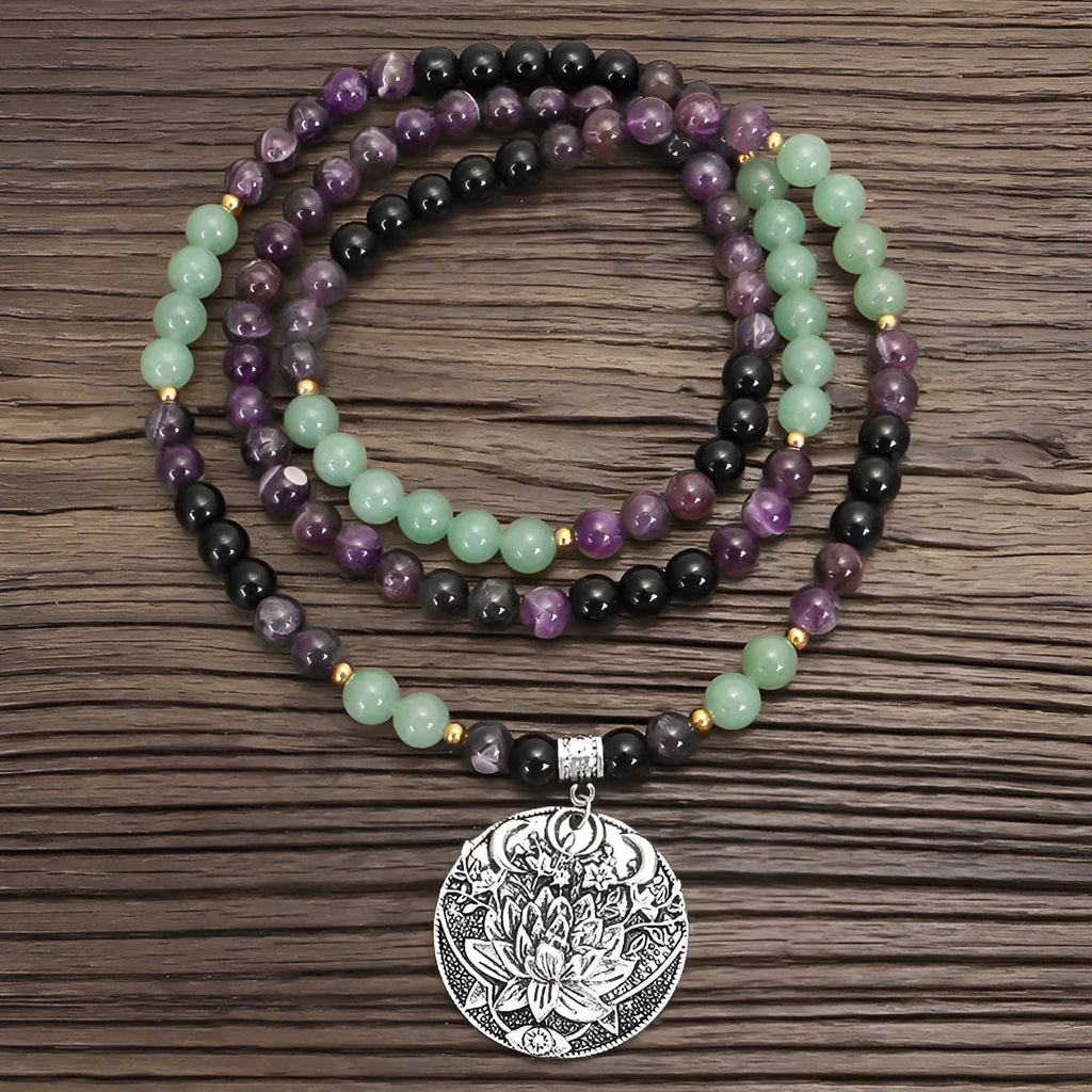Long yoga lotus pendant necklace and matching bracelet set with stone beads and geometric design.