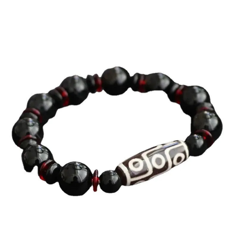 Hand-woven black agate Dzi bracelet with geometric 11mm beads on wrist