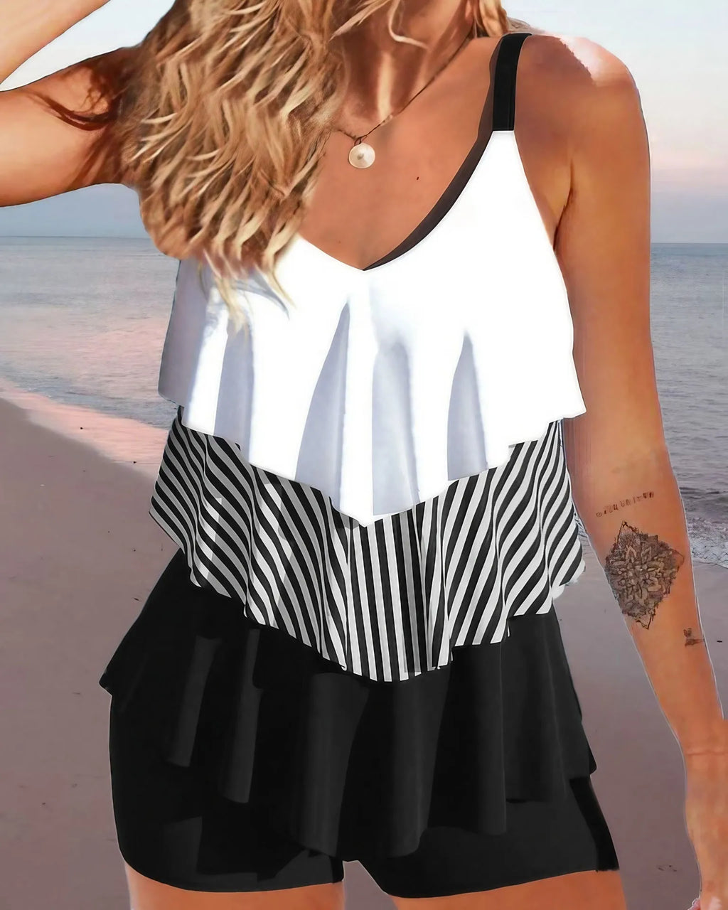 Women's backless bikini swimsuit with spaghetti straps and ruffle detail in a choice of patterns.